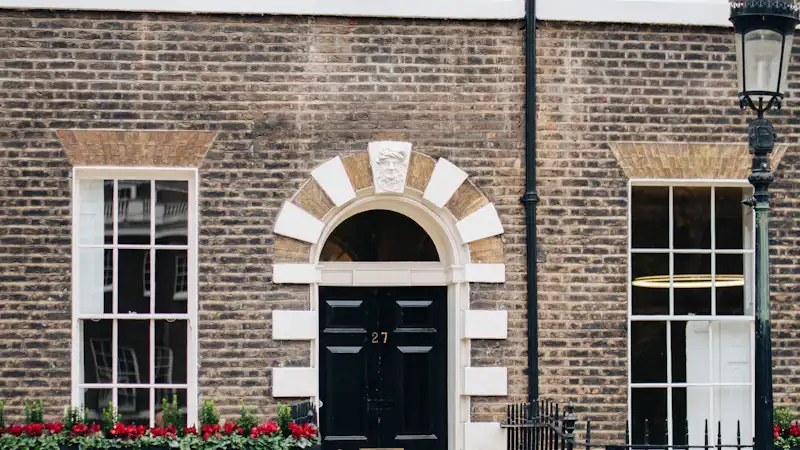 London brick terrace with sash windows and an arched doorway