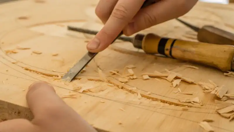 Chisel shaping a piece of timber